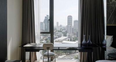 Modern bedroom with a study desk and city view