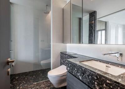 Modern bathroom with marble countertop and glass shower