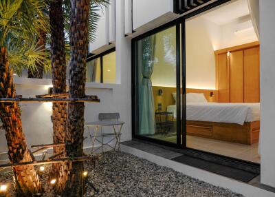 Modern Bedroom with Glass Door Opening to a Courtyard
