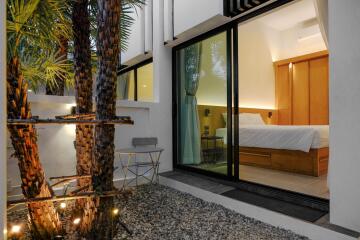 Modern Bedroom with Glass Door Opening to a Courtyard