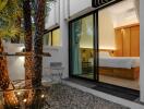 Modern Bedroom with Glass Door Opening to a Courtyard