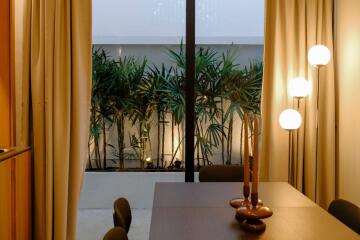 Well-lit dining area with a view of the garden