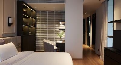 Modern bedroom with wooden flooring, built-in shelves, a desk, and nightstands with lighting