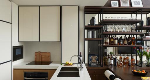Modern kitchen with sleek cabinetry and a stocked bar