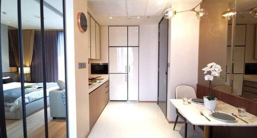 Modern kitchen with dining area and view of bedroom