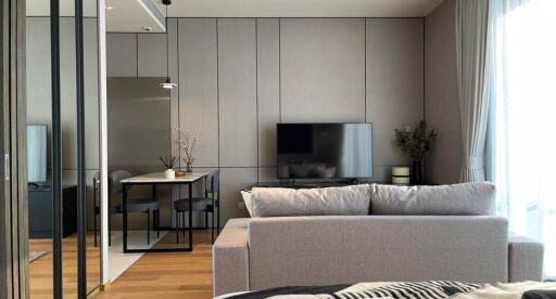 Modern living room with a flat-screen TV and dining area