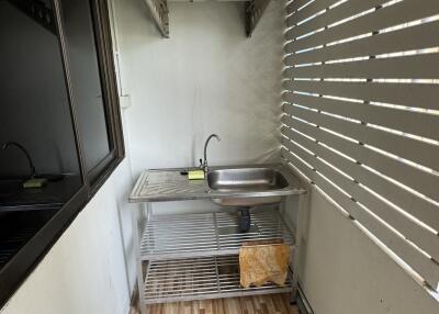 Utility area with a stainless steel sink and air conditioning unit