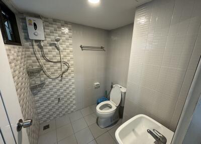 Modern bathroom with shower, sink, and toilet