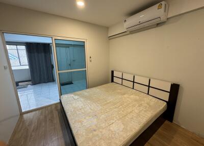 Bedroom with a bed and air conditioning unit