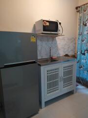 Compact kitchen with fridge and microwave