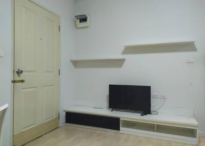 Minimalist living room with wall-mounted TV and shelves