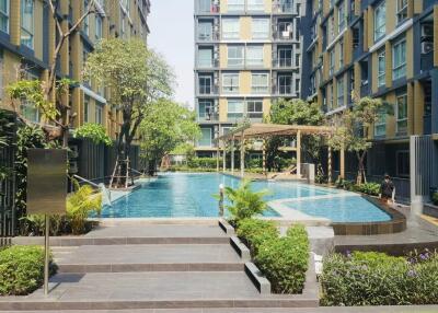 Swimming pool area surrounded by multi-story residential buildings