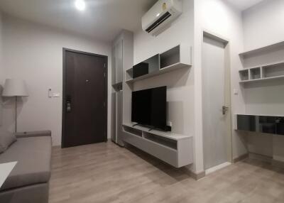 Modern living room with wall-mounted TV and air conditioning