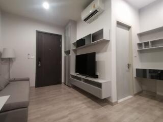 Modern living room with wall-mounted TV and air conditioning