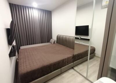 Modern bedroom with large bed and mirrored wardrobe