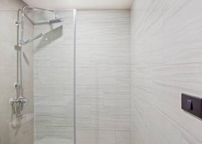 Minimalist bathroom with glass shower enclosure