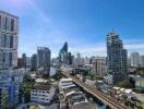 City skyline with multiple high-rise buildings under a clear blue sky