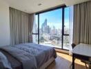 Bedroom with large window and city view