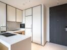 Modern kitchen with white cabinets, integrated appliances, and a sink