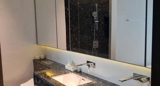 Modern bathroom with marble counter and large mirror