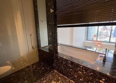 Modern bathroom with marble flooring and large window view