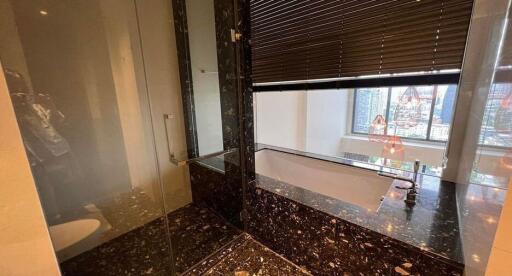 Modern bathroom with marble flooring and large window view