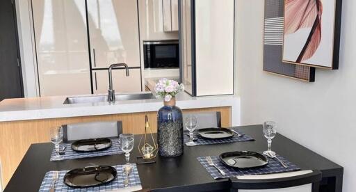 Modern dining area with a kitchen in the background