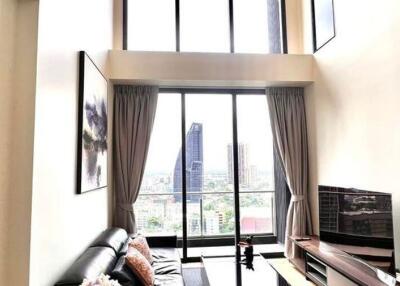 Modern high-ceiling living room with large windows and city view