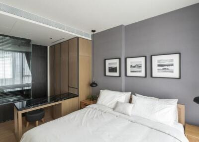 Modern bedroom with large bed, wooden nightstands, and wall art