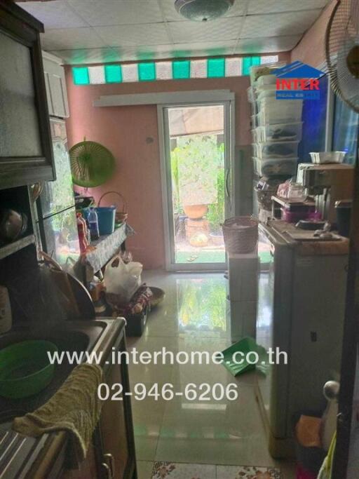 Small kitchen area with storage and garden view