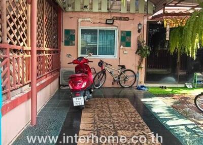 Covered outdoor area with motorcycle and bicycle