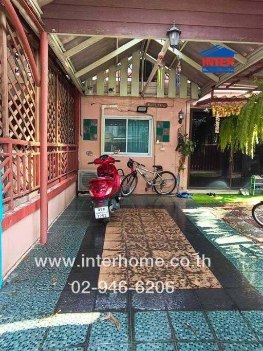 Covered outdoor area with motorcycle and bicycle