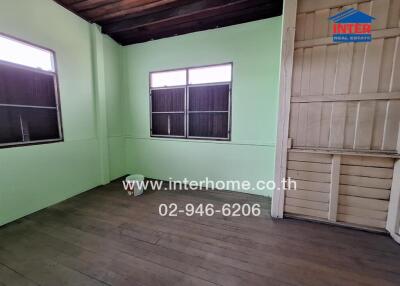 Empty room with wooden floor and windows