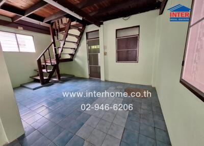 Spacious living area with stairs and tiled floor
