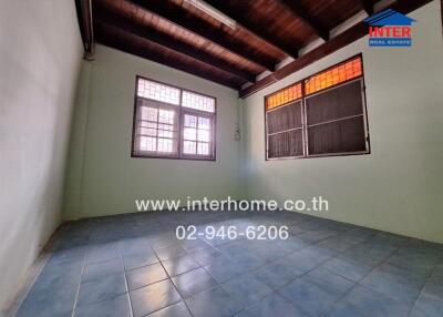 Unfurnished room with tiled floor and wooden ceiling