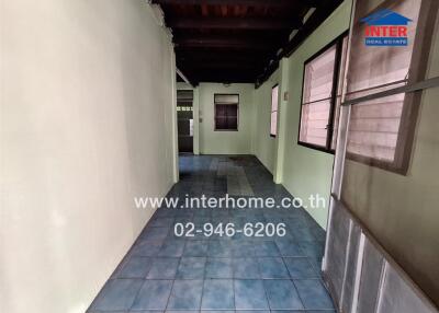 Indoor walkway with tiled floor and windows