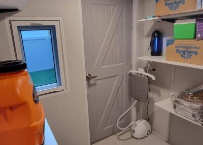 Utility room with shelves and cleaning equipment