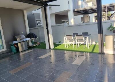 Outdoor patio area with barbecue grill and dining table