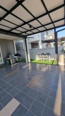 Outdoor patio area with barbecue grill and dining table