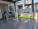 Outdoor patio area with barbecue grill and dining table