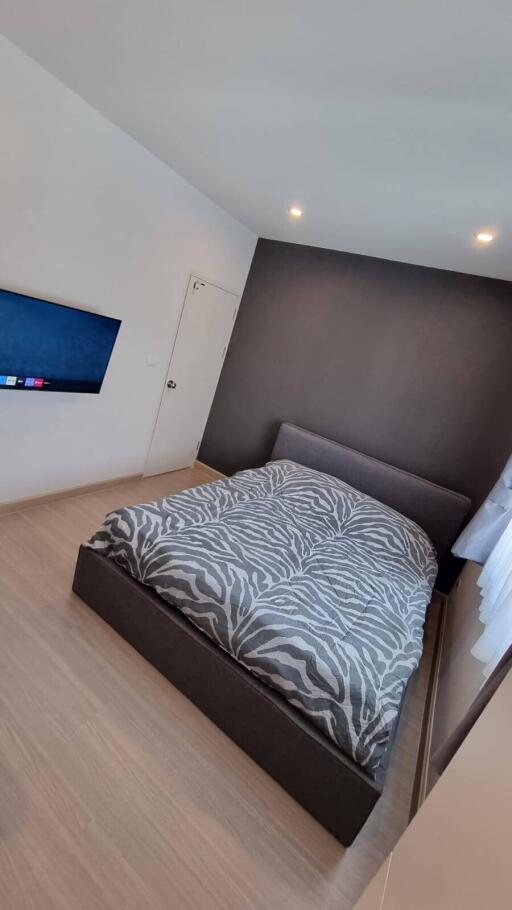 Modern bedroom with a mounted TV and a large bed