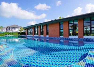 Outdoor pool area with adjacent modern building