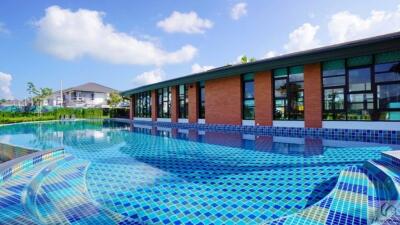 Outdoor pool area with adjacent modern building