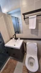 Modern bathroom with vanity, mirror, toilet, and shower