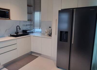 Modern kitchen with appliances and white cabinetry