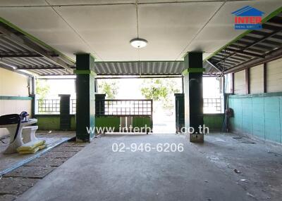Covered outdoor area with open gate and bench