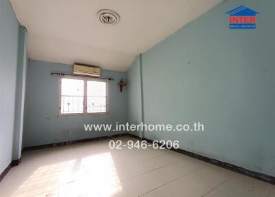 Empty bedroom with tiled floor and air conditioning unit