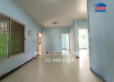 Spacious living area with tiled flooring and blue walls