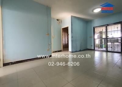 Empty living room with blue walls and tiled floor