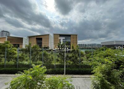 Modern buildings with green surroundings and cloudy sky